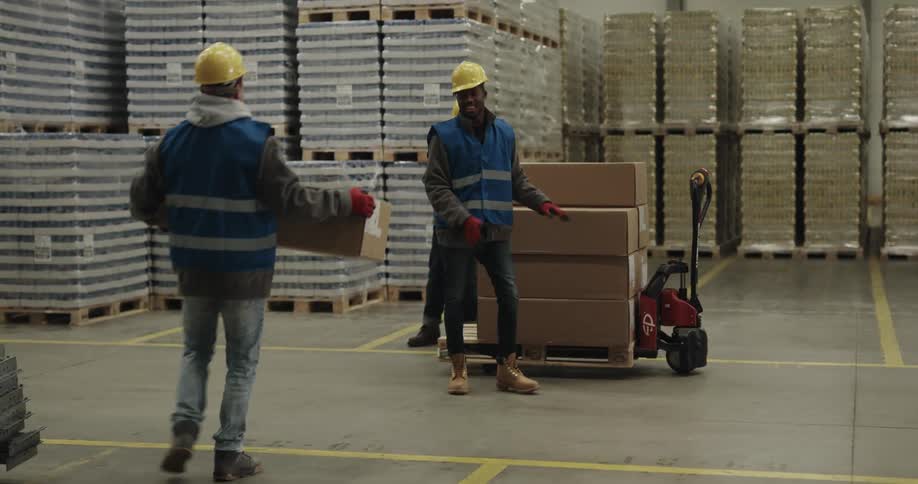 Three employees are working in a warehouse