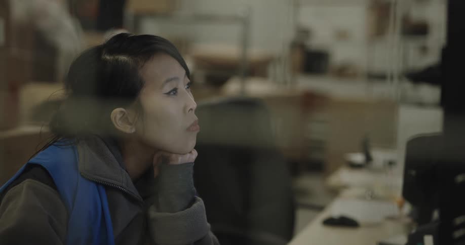 Woman wroking in the office on a warehouse in front of a computer