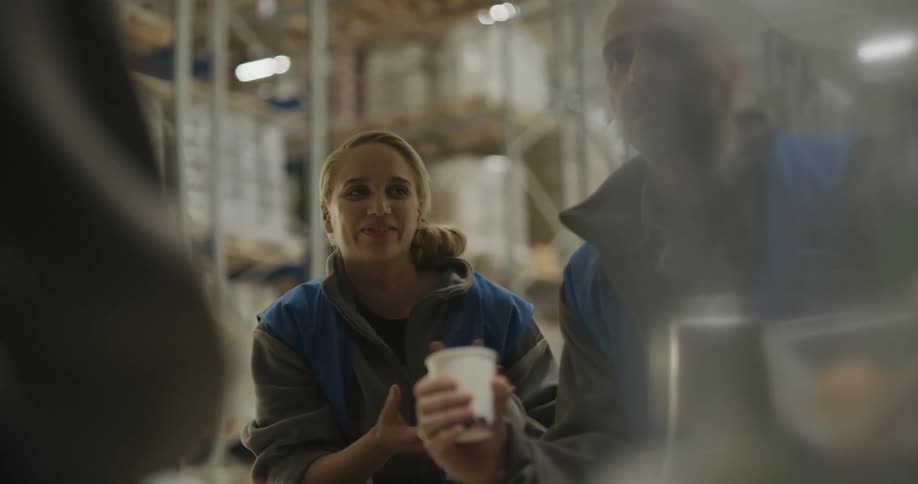 Employees on a warehouse sharing apples during a break