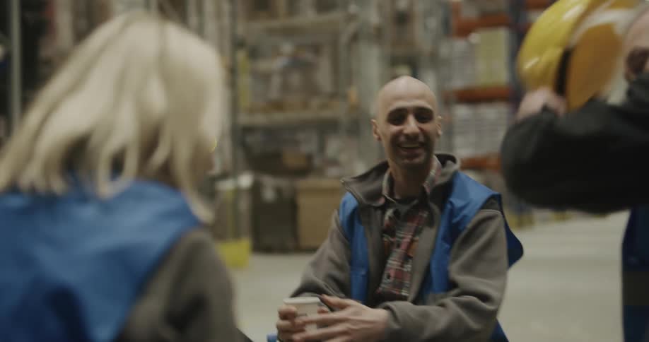A group of workers in a warehouse together