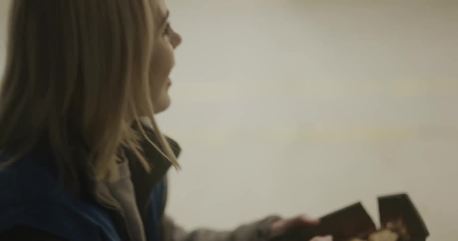 Woman sharing cookies with her coworkers during her lunch break