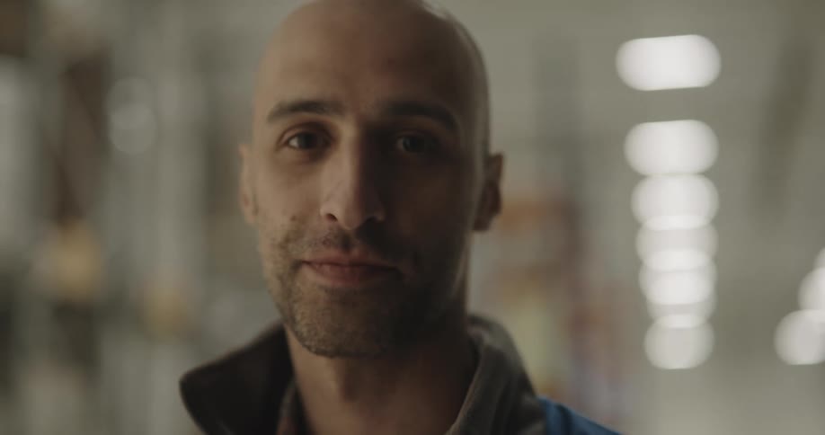 Man stands smiling in hallway
