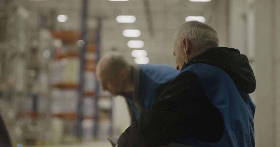 Workers in a factory talk together on break