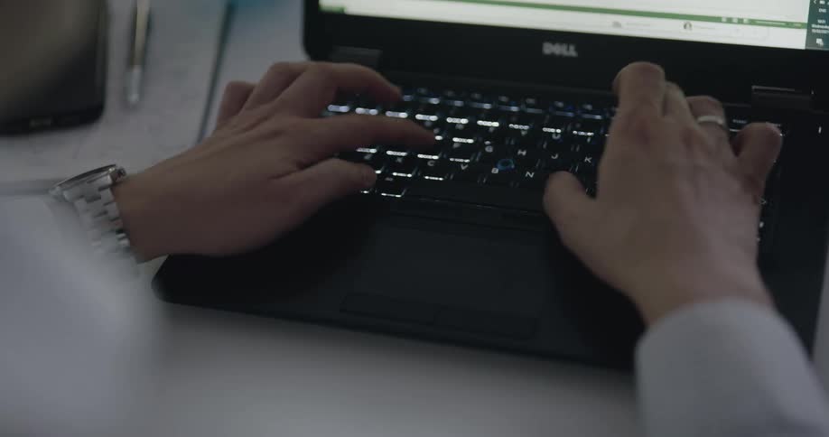 Blonde woman works on laptop in the office