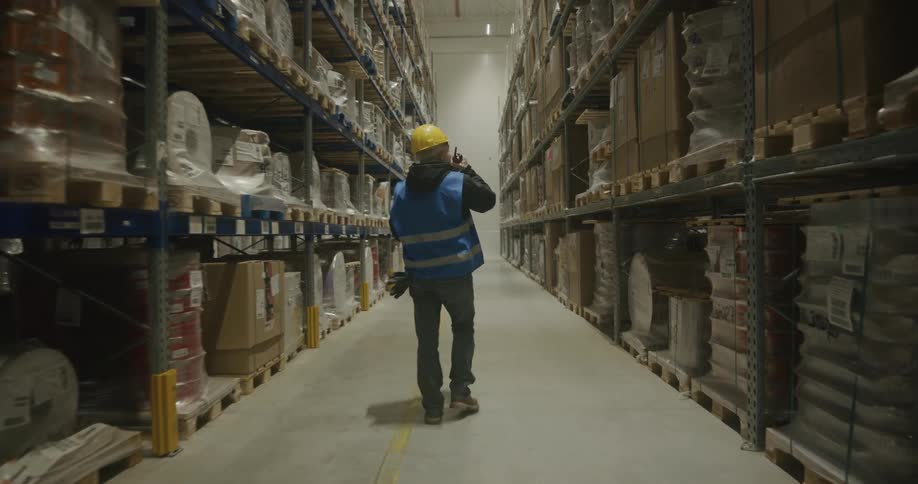 A man walking around in a warehouse