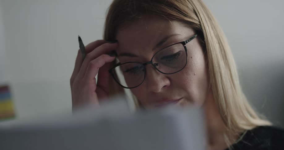 Woman working at the office checking documents on her desk