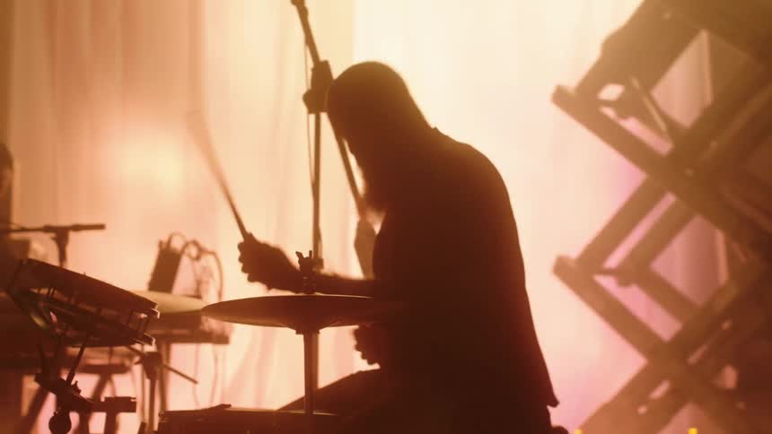 A group of people playing instruments on a stage
