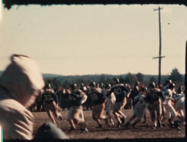 A 1950's game of high school football is played in Vermont during the fall