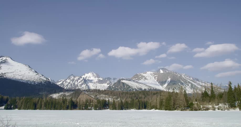 A hotel sits in front of the snowy mountains