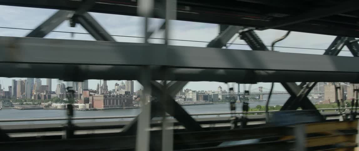 Moving over a bridge with a city across the water