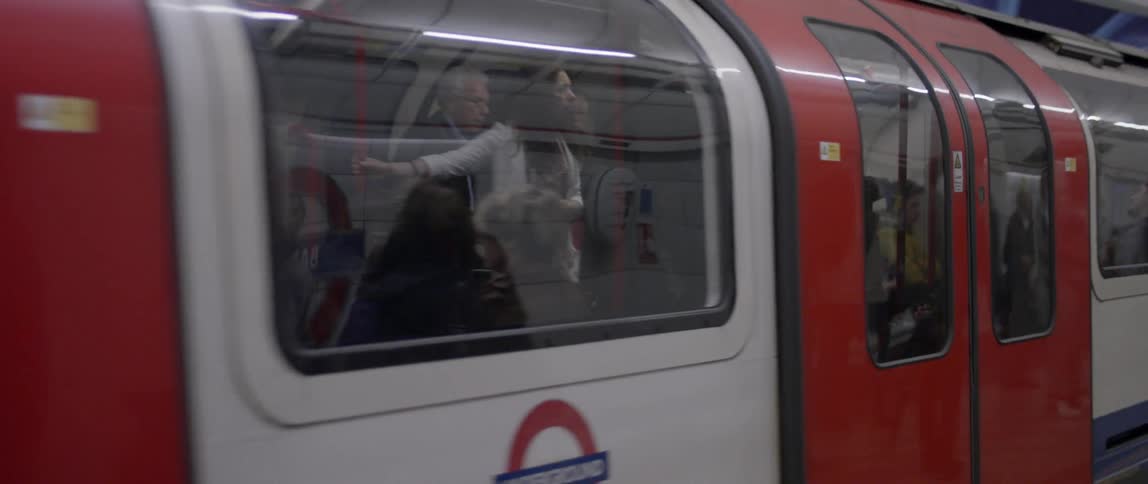 A train full of people pulling away