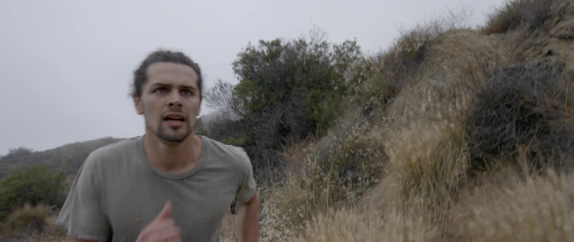 Man running along a path in the wilderness