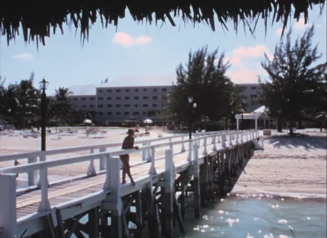 A woman standing outside on a pier looking into the distance