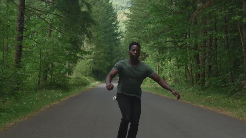 A man is riding his skateboard on the road