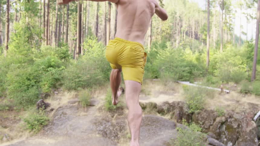 A man is running outdoors in a forest