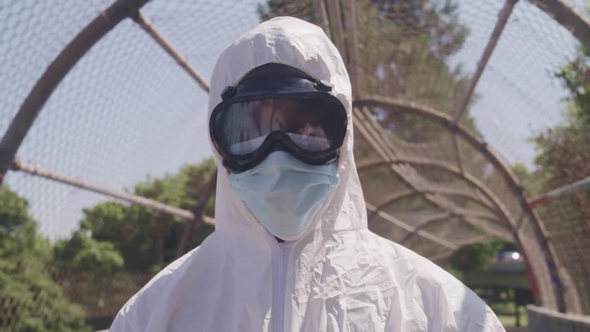 A person is standing outdoors and wearing goggles