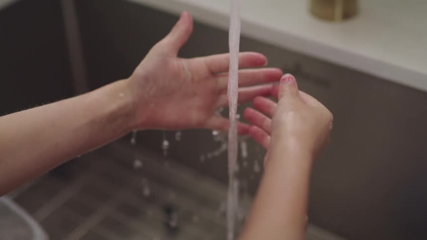 A person is washing their hands in the sink