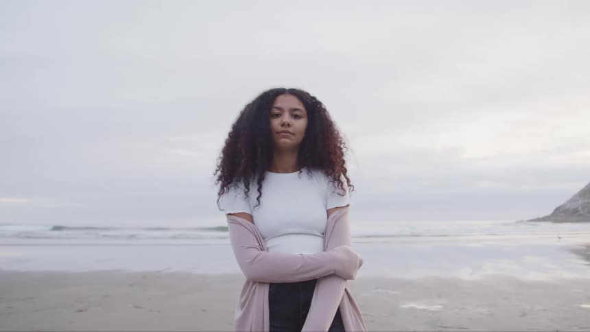 A woman is standing on the beach