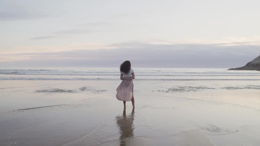 A woman that has a portrait taken at a beach