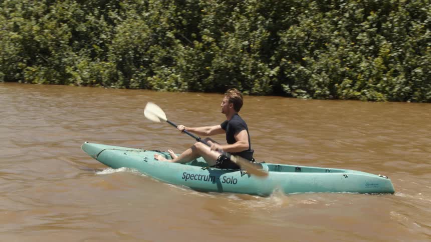 Man paddles a canoe in the river