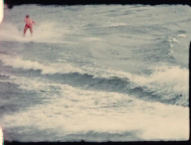 A man water skiing behind a boat