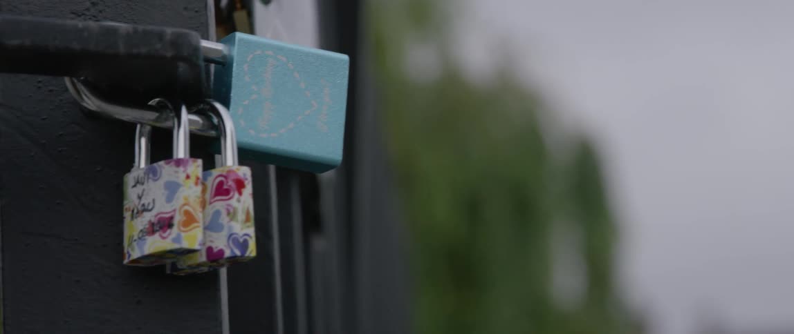 Locks with messages of love attached to a fence