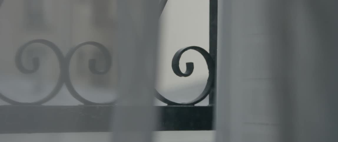 Close up of a curtain and railing