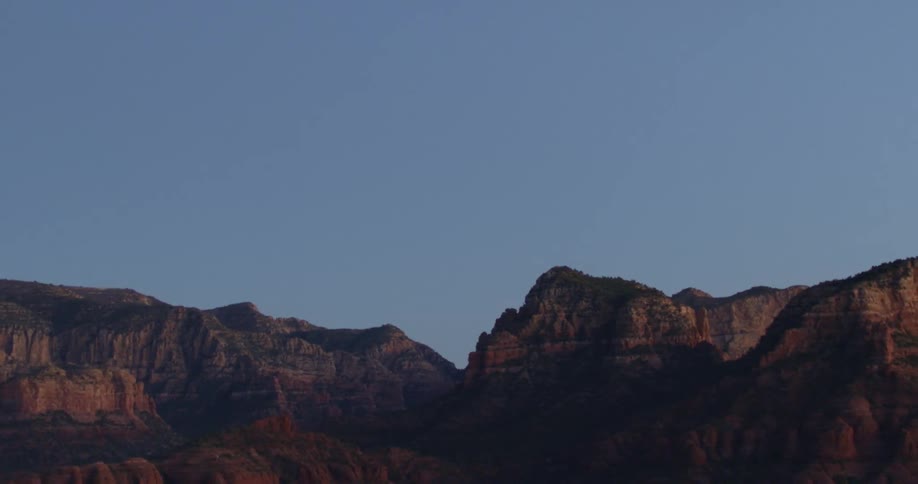 Rocky mountain and rough terrain under clear a blue sky