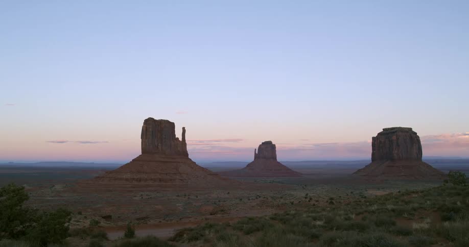 A desert with cliffs and the sky in the background