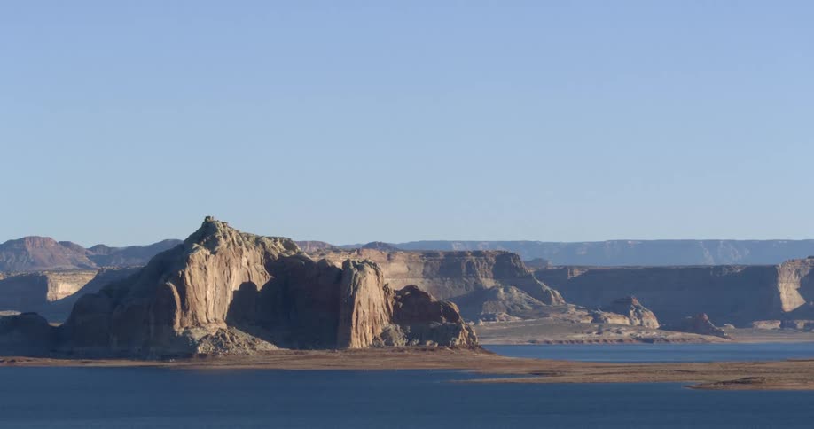 The rocks and hills are near the shore ahead