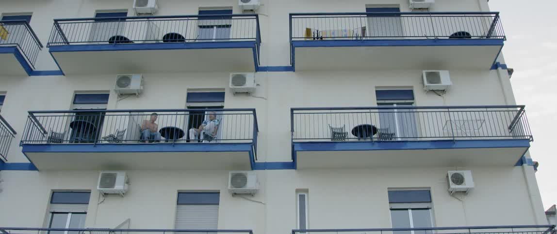An apartment building is lined with balconies