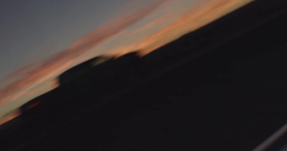 Cars reflect in the light on a car window