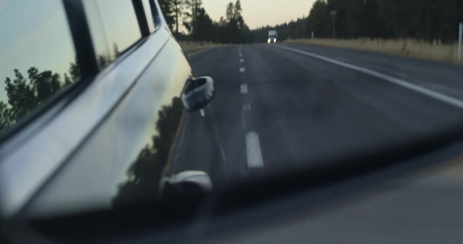 A car and truck drive along a street