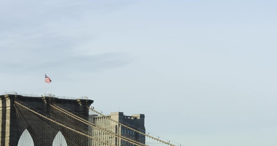 A bridge with the american flag waving on top of it