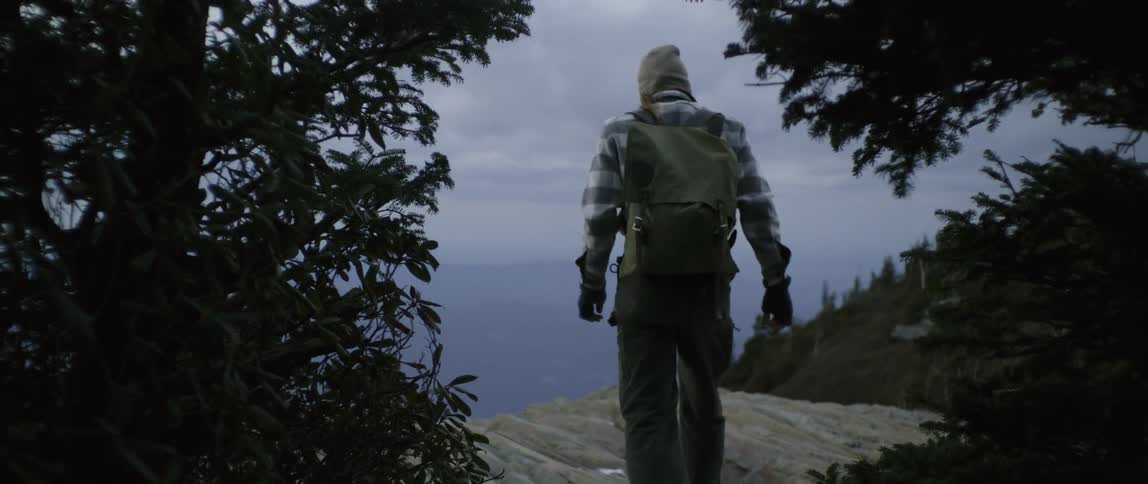 A man hikes in mountains