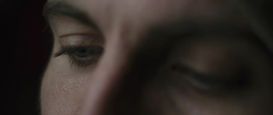 Women stares downward then opens her eyes wide