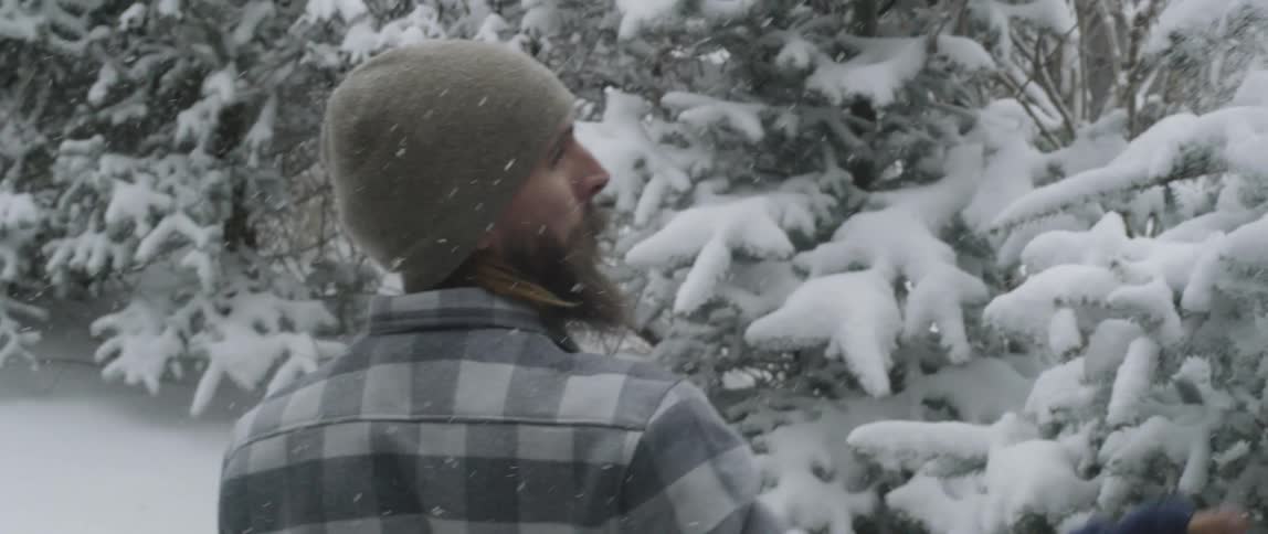 A man walks outside in a snowstorm