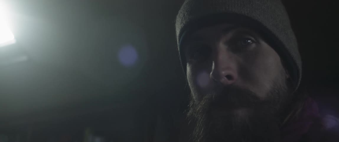 Man with beard in beanie gazing
