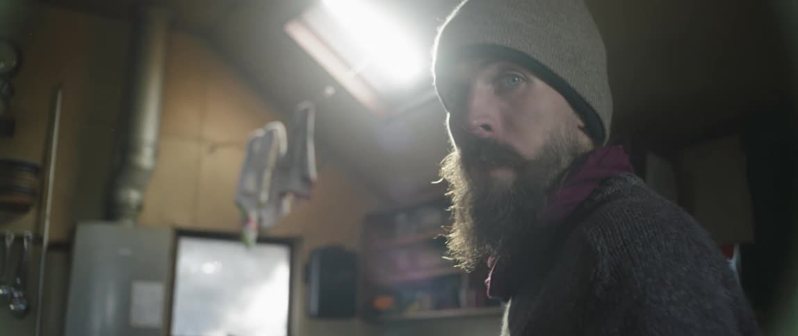 Man with beard in beanie gazing