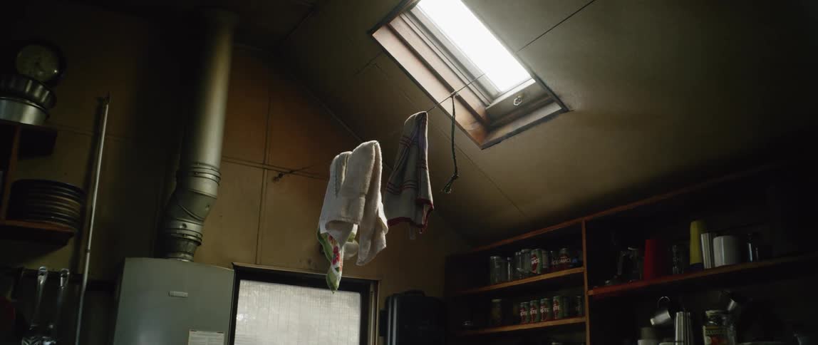 Towels hang on a wire under the sky light