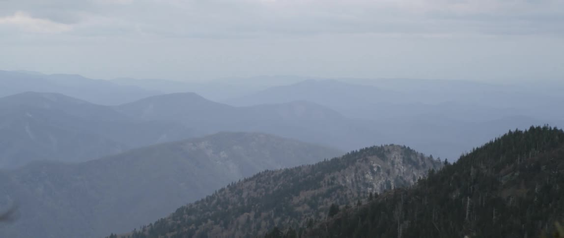 Layers of mountain ranges on cloudy day