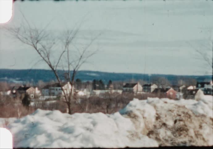Snow covers a small New England town in the 1950's