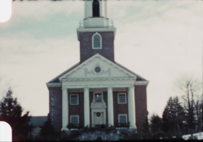 Small church in a rural town covered in snow caught on vintage film