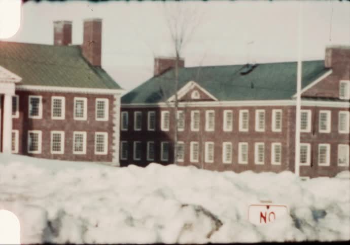 A view of buildings with snow outside of them