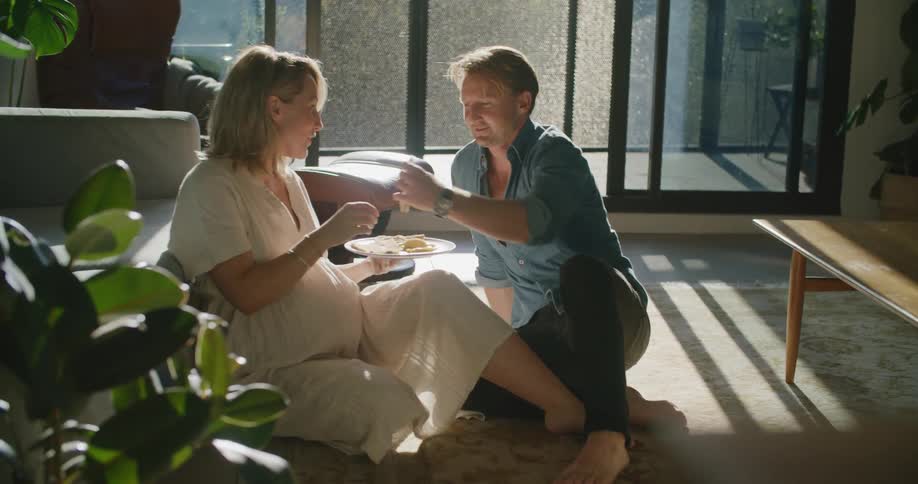 Two people that are eating on the floor