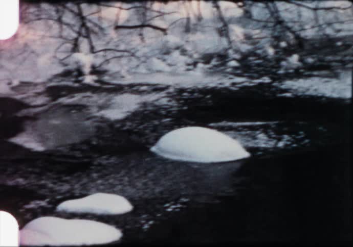 Ice and snow over a river in the countryside caught on vintage film