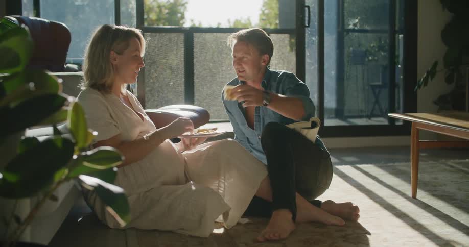 A man and woman talking and eating
