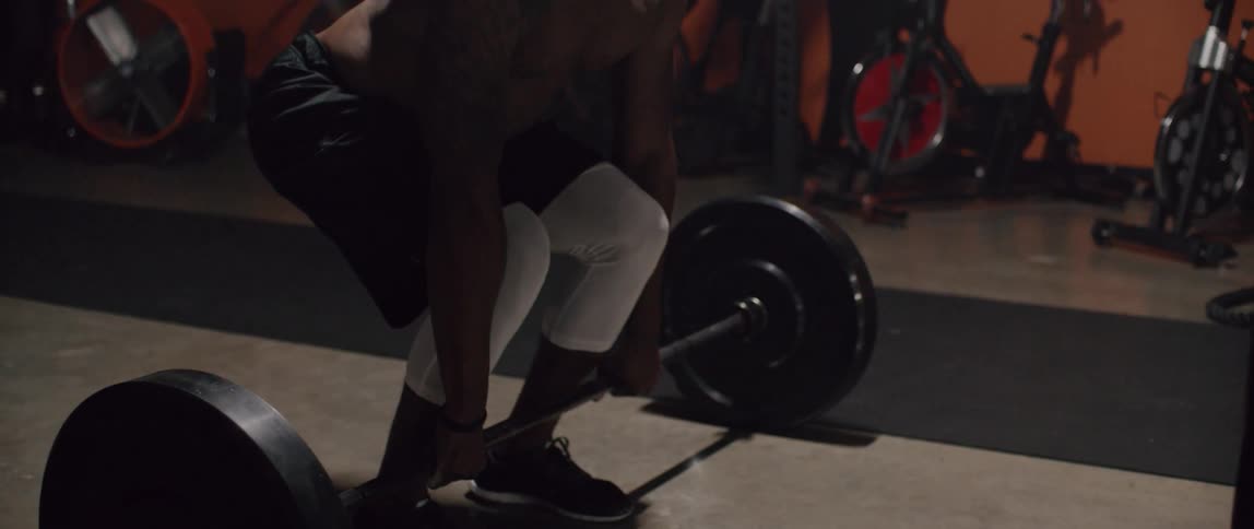 A man is lifting weights in the gym