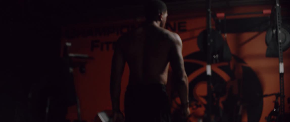 Man in boxing gym exercises