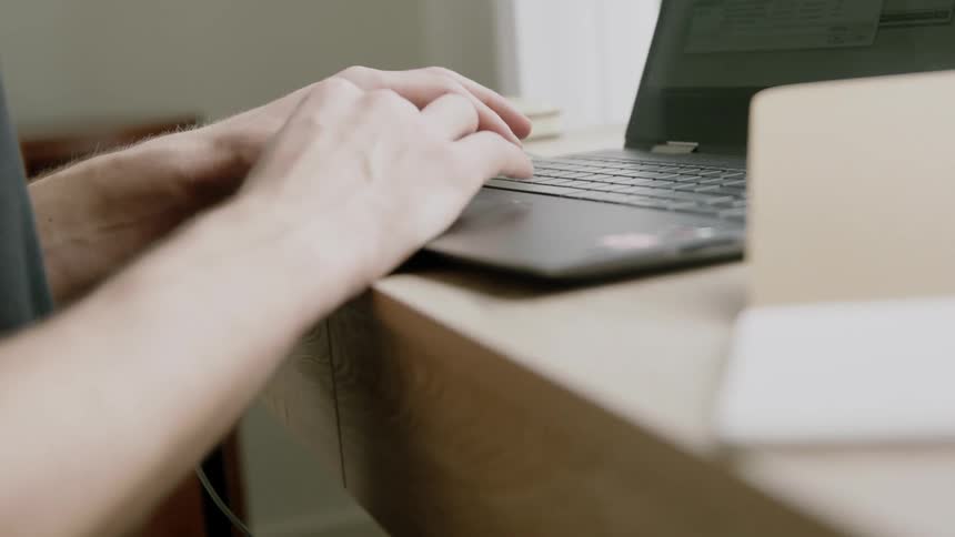 An employee working on a laptop in an office